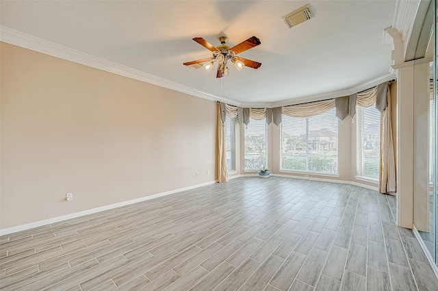 spare room featuring ornamental molding, a wealth of natural light, and ceiling fan