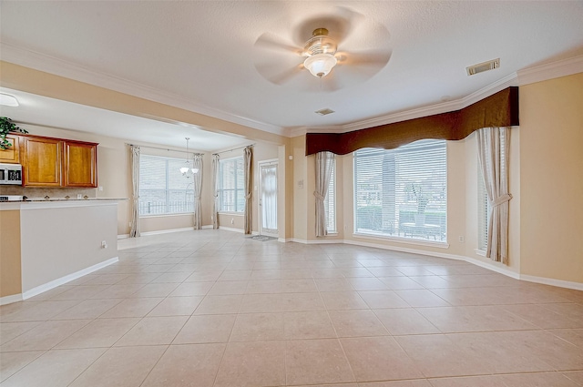 tiled empty room featuring ornamental molding and ceiling fan with notable chandelier