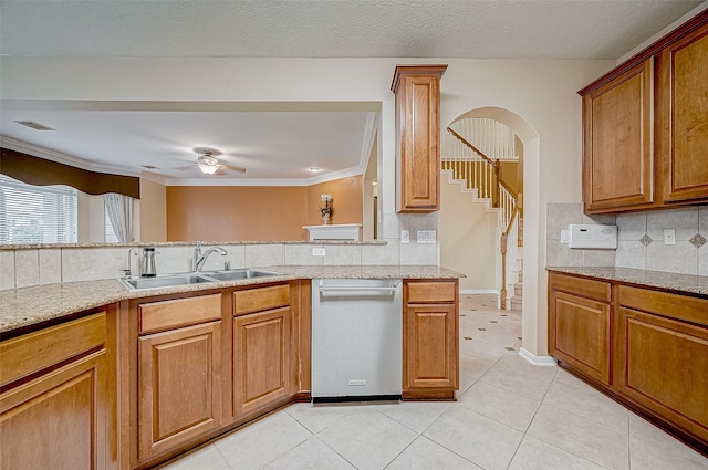 kitchen featuring tasteful backsplash, dishwasher, sink, light tile patterned floors, and ceiling fan