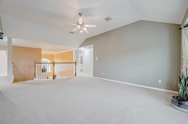 spare room featuring carpet floors, vaulted ceiling, and ceiling fan