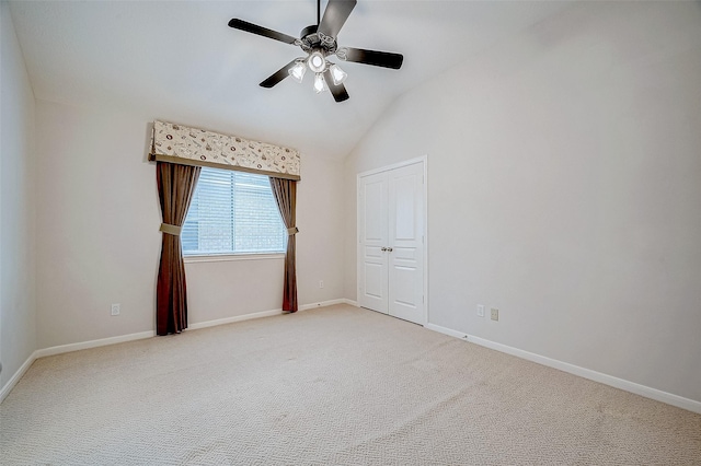 unfurnished room with lofted ceiling, light colored carpet, and ceiling fan