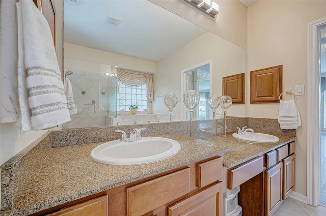 bathroom featuring tile patterned floors, vanity, and an enclosed shower