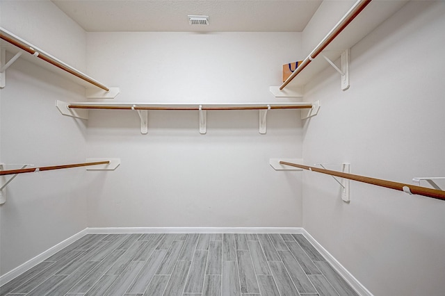 walk in closet featuring hardwood / wood-style flooring