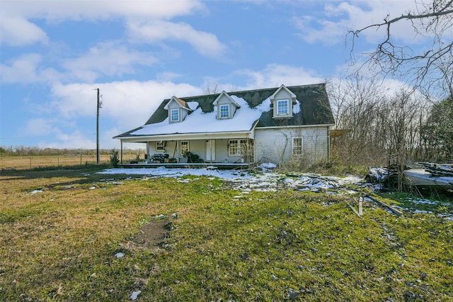 view of front of home with a front yard and covered porch