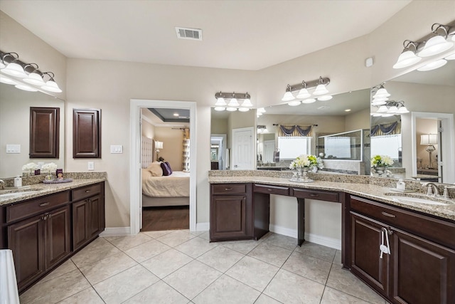 bathroom with tile patterned flooring, sink, and a shower with shower door