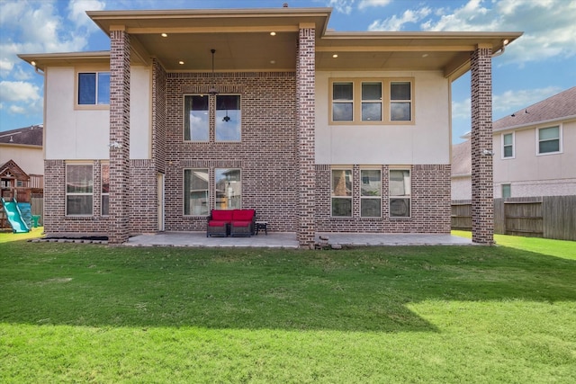 back of property featuring a yard, a patio, and a playground