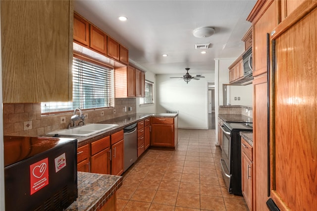 9219 Timberside Dr, Houston, TX 77025 - kitchen with stainless steel appliances, backsplash, ceiling fan, light tile patterned flooring, and brown cabinets