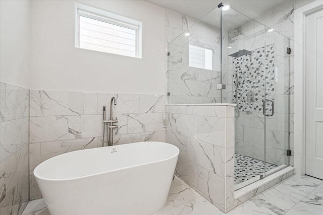 bathroom with separate shower and tub and tile walls