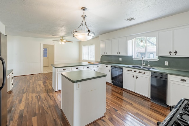 kitchen with white cabinetry, dishwasher, and decorative light fixtures