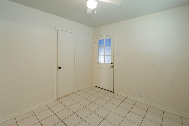 tiled empty room with ceiling fan