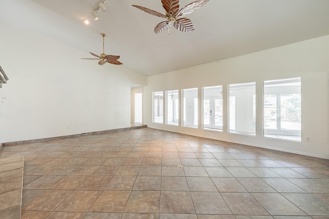 tiled spare room with ceiling fan, lofted ceiling, and rail lighting