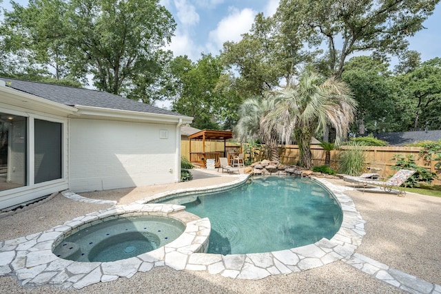 view of pool featuring an in ground hot tub and a patio