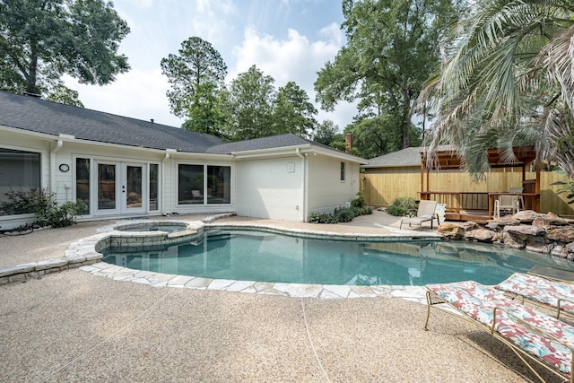 view of pool with an in ground hot tub, a patio, and french doors