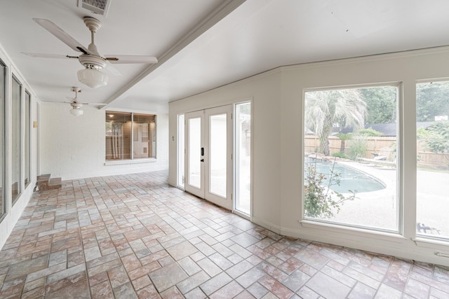 interior space featuring ornamental molding, a wealth of natural light, ceiling fan, and french doors