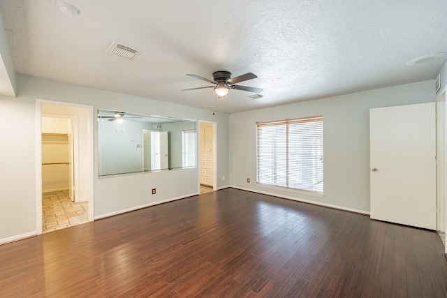 spare room with hardwood / wood-style flooring, a textured ceiling, and ceiling fan