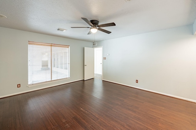 unfurnished room featuring dark wood-type flooring, ceiling fan, and a textured ceiling