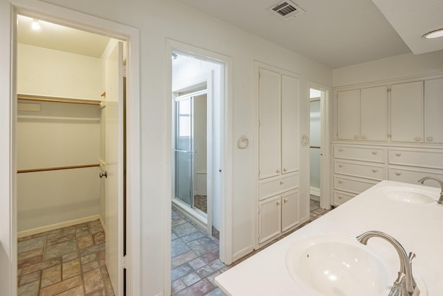 bathroom featuring vanity and an enclosed shower