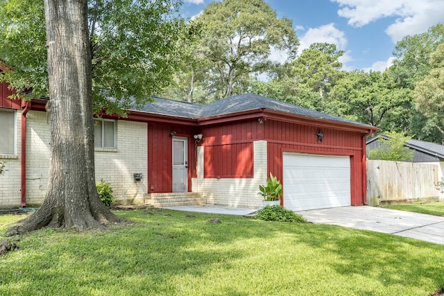 ranch-style home featuring a garage and a front lawn