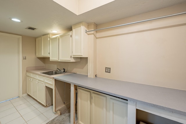 kitchen featuring sink and light tile patterned floors