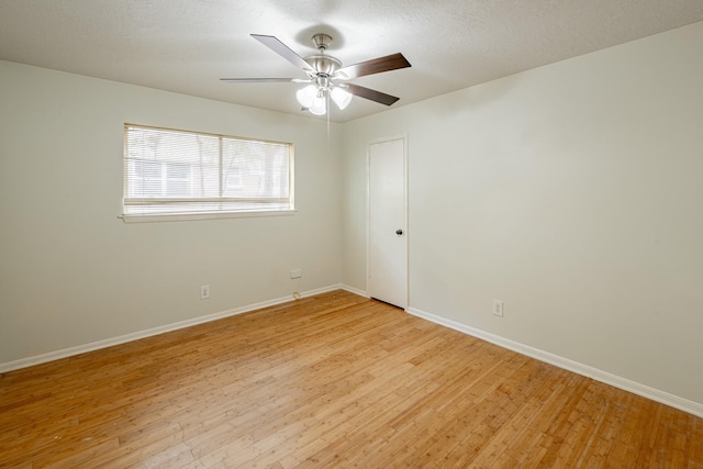 empty room featuring ceiling fan, a textured ceiling, and light wood-type flooring