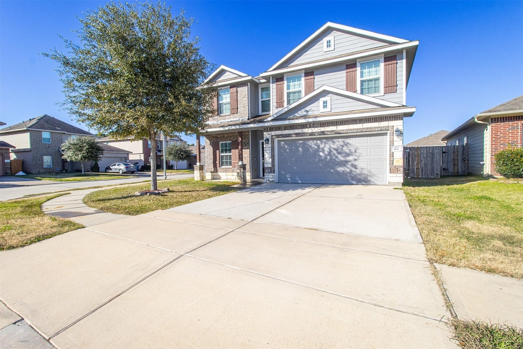 view of property with a garage and a front yard