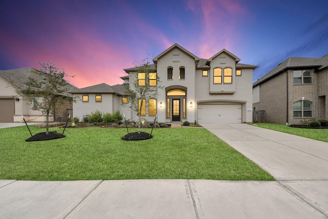 view of front facade featuring a garage and a yard