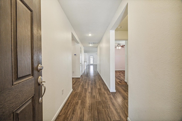 hall with dark hardwood / wood-style floors