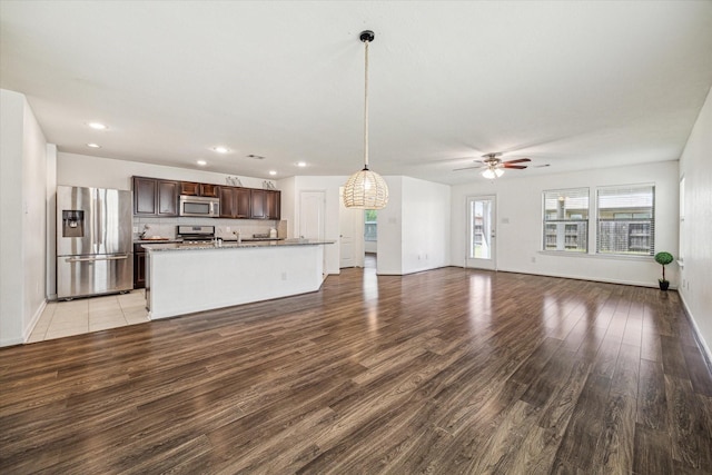 unfurnished living room with ceiling fan and light hardwood / wood-style floors