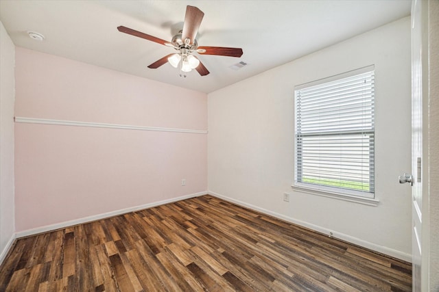 empty room featuring dark hardwood / wood-style flooring and ceiling fan