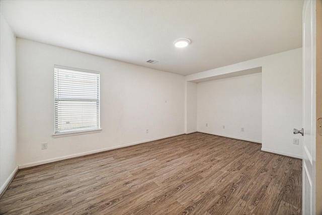 empty room featuring wood-type flooring