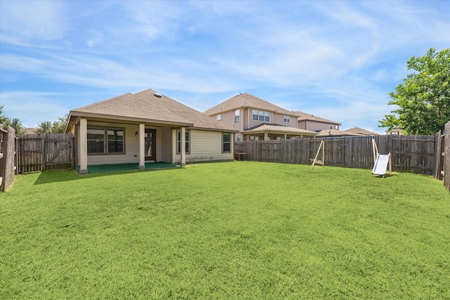 rear view of property with a lawn