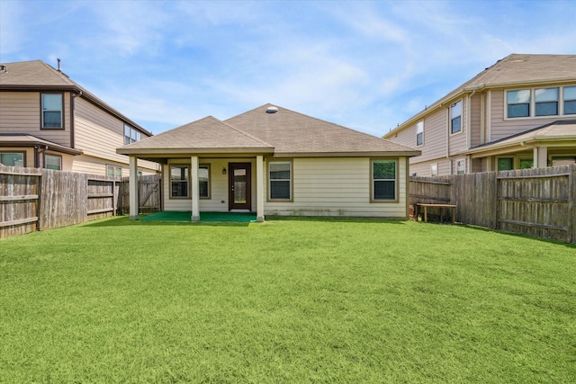 back of house featuring a patio and a lawn