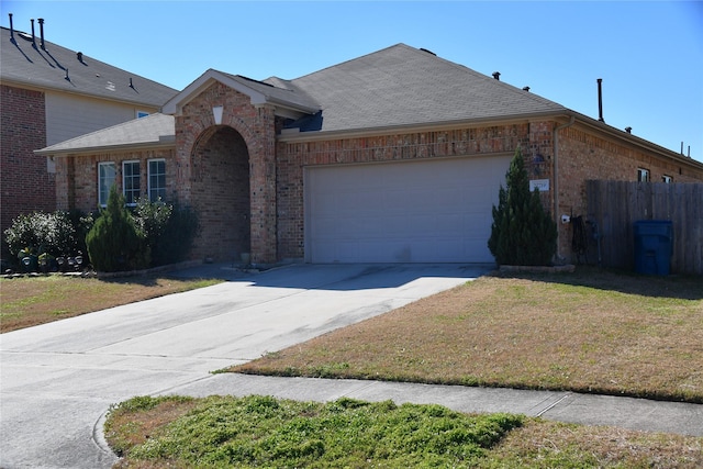 single story home with a garage and a front yard