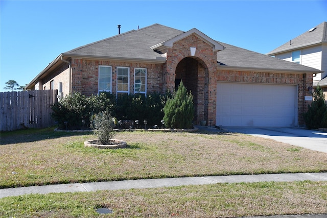 view of front of home featuring a garage and a front lawn