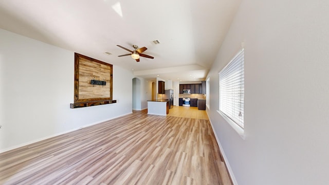 unfurnished living room featuring hardwood / wood-style floors and ceiling fan