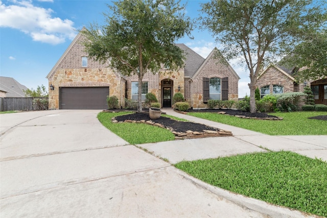 view of front of house with a garage and a front yard