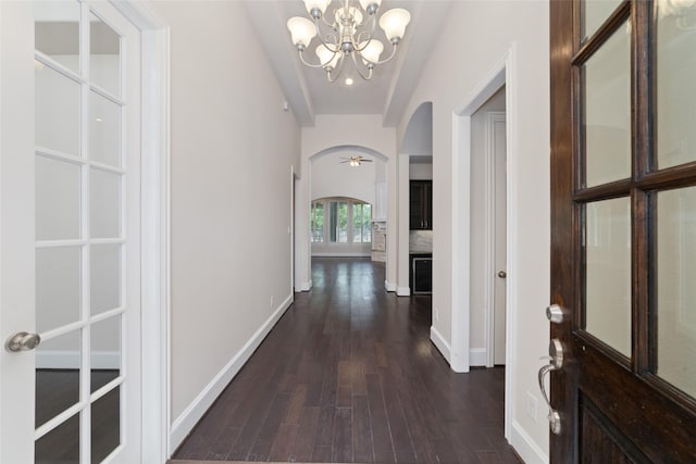 hallway featuring a notable chandelier and dark hardwood / wood-style floors