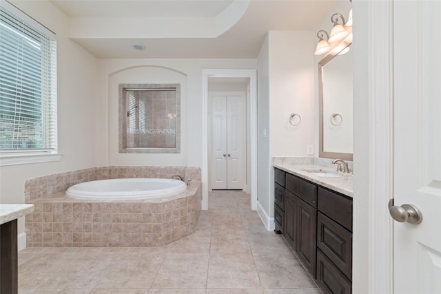 bathroom with vanity, tiled tub, and tile patterned flooring