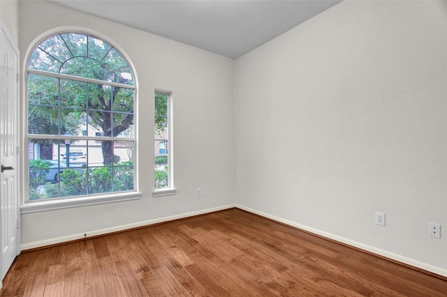 unfurnished room with hardwood / wood-style floors