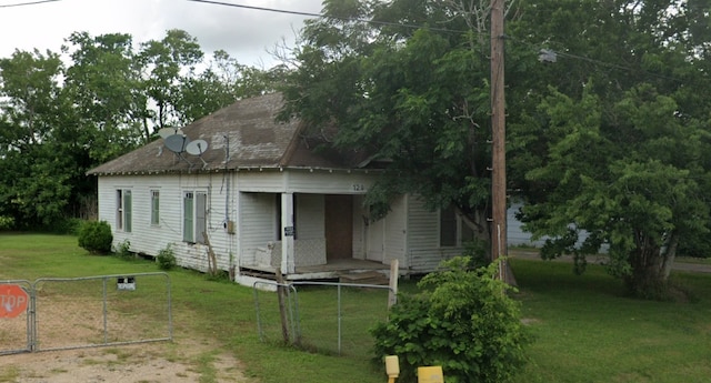 rear view of property featuring a yard