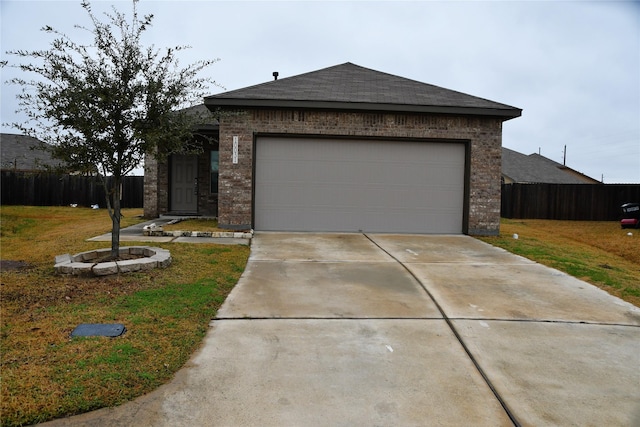 view of front of house featuring a garage and a front yard