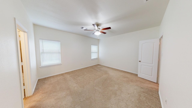 empty room featuring light carpet and ceiling fan