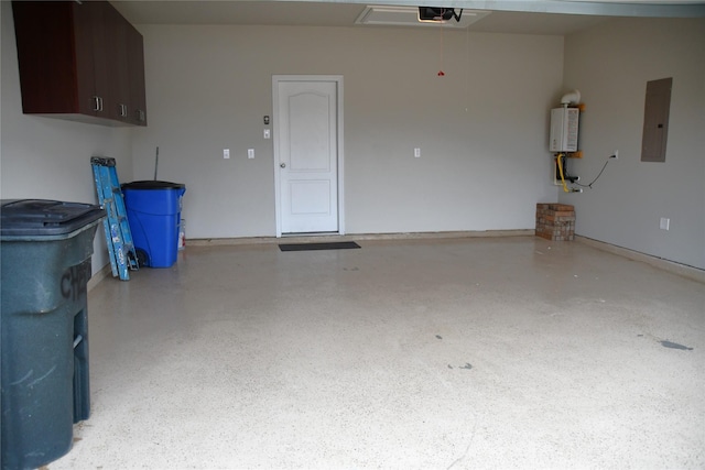 garage featuring water heater, a garage door opener, and electric panel