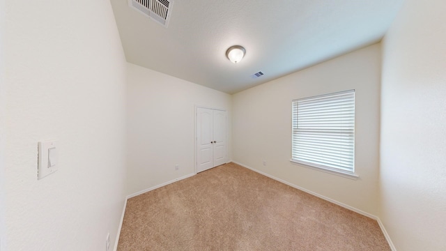 spare room with light colored carpet