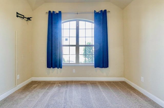 empty room with lofted ceiling and carpet