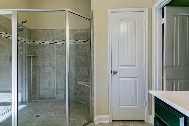 bathroom featuring an enclosed shower and vanity