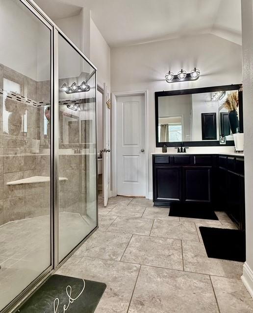 bathroom with vanity and a shower with shower door