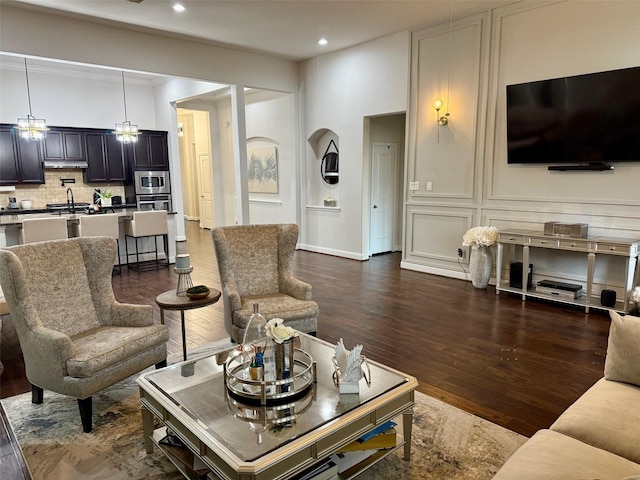 living room with sink and dark hardwood / wood-style floors