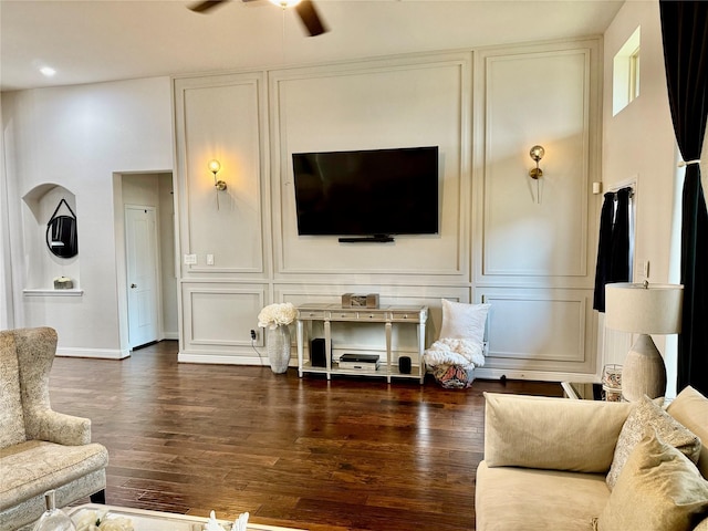 living room with ceiling fan and dark hardwood / wood-style floors