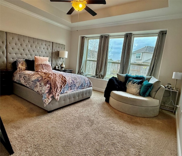 bedroom with ornamental molding, a raised ceiling, and multiple windows